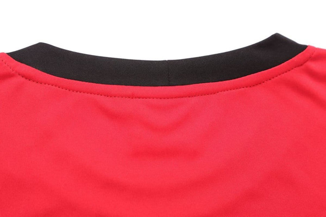 A red T-shirt featuring a black neckline, with a smooth fabric texture and stitching details.