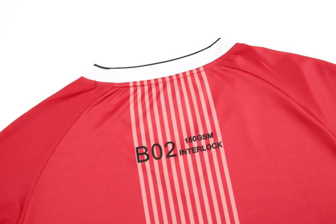 A red long-sleeved crew top featuring a white collar and a logo on the back. It has striped design elements.