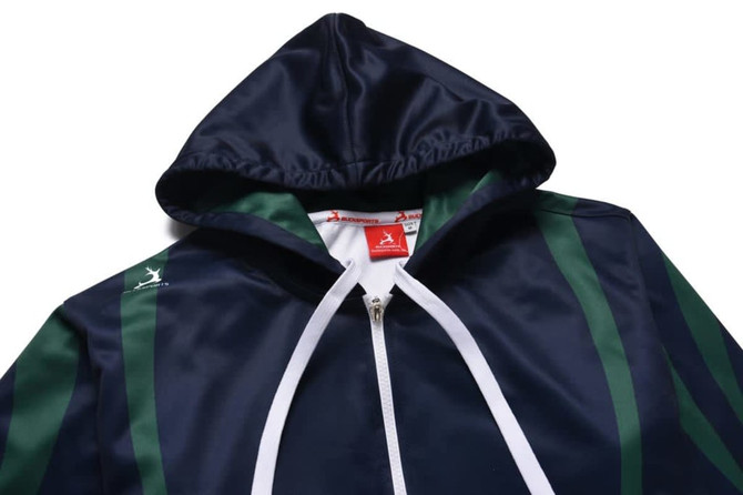 A navy and green sports hoodie with a zip and a hood, featuring a logo on the front.