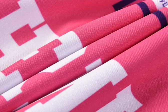 A vibrant pink hoodie with a quarter zipper, featuring a textured fabric and a logo.