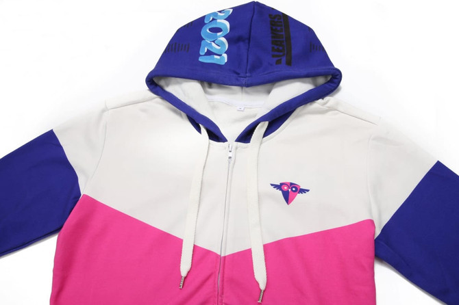 A cotton hoodie featuring a purple, white, and pink colour block design, with a logo on the chest and a zip front.
