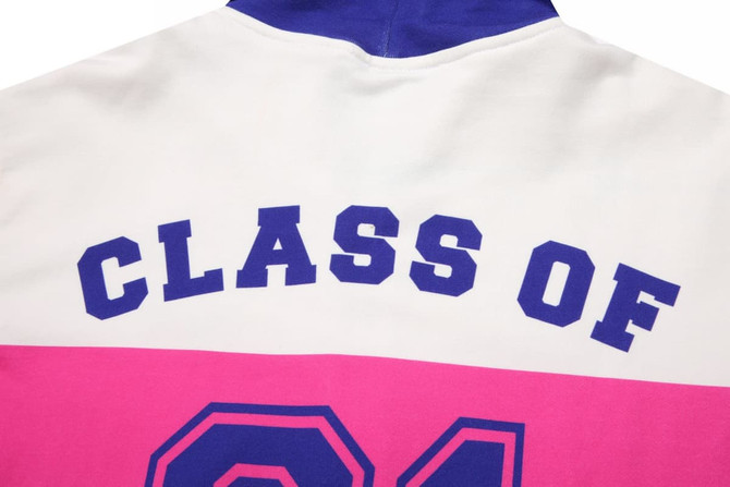 A cotton hoodie featuring a white, pink, and purple design with "CLASS OF" printed on the back and a logo.