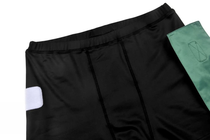 Black TAG SHORTS featuring a green accent and a logo on the fabric.