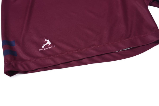 A maroon sports shirt featuring a logo and blue stripes along the hem.