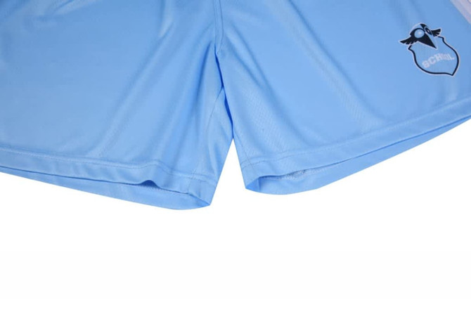Light blue shorts featuring a logo on the side. The fabric appears smooth and lightweight.