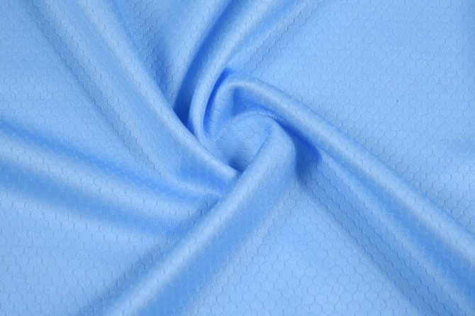 A light blue fabric with a subtle honeycomb pattern, showcasing a smooth, soft texture.