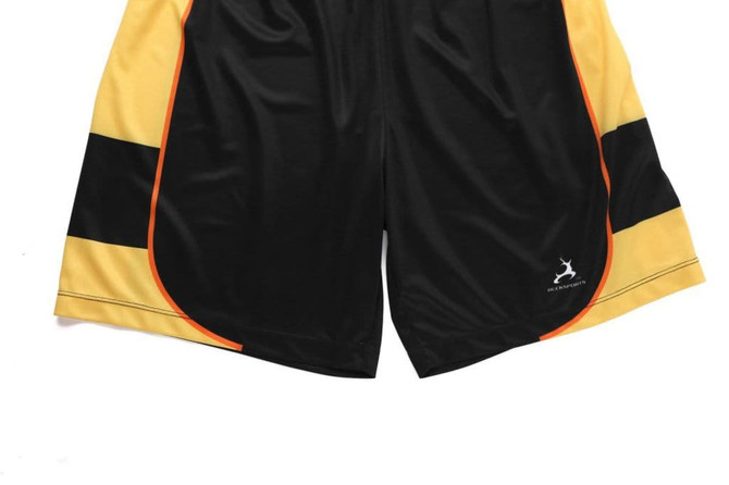Black training shorts with yellow and orange accents, featuring a logo on the hem.