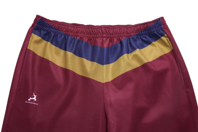 Maroon training pants featuring blue and gold stripes along the waistline; includes a logo on the side.