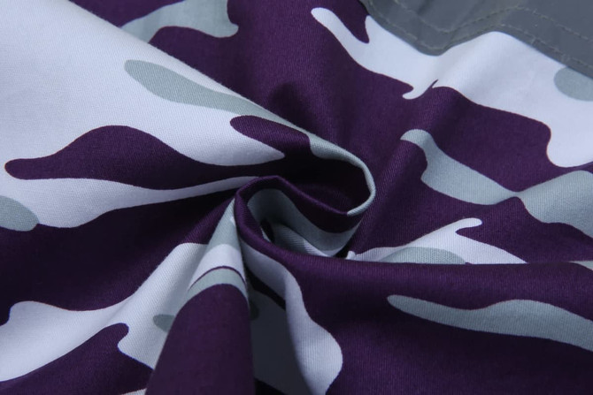 A close-up of a purple and grey camo fabric, highlighting the texture and pattern of the material.