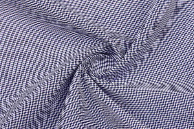 A close-up of fabric featuring a blue and white checkered pattern, showcasing its texture and weave.