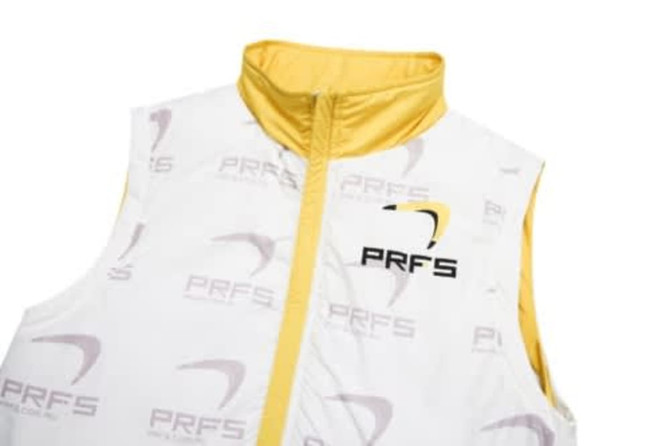 A white and yellow sleeveless winter coat with a zip and a logo. Features a puffer design for warmth.