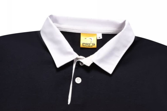 A sports jumper in navy blue with a white collar, featuring a logo on the label.