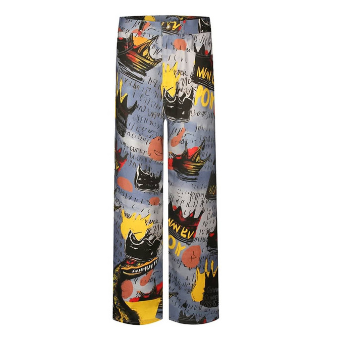 Colourful patterned pants featuring abstract designs in black, yellow, and grey, with a loose-fit style and an elastic waistband.