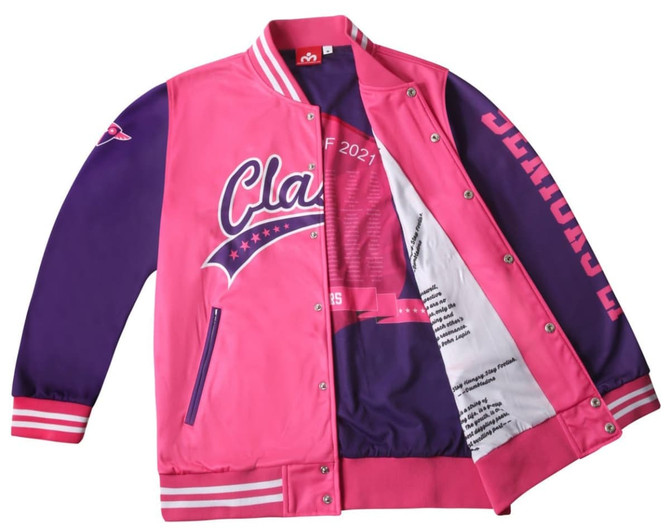 A pink and purple varsity jacket featuring a logo and printed lining. The jacket has striped cuffs and a bold design.