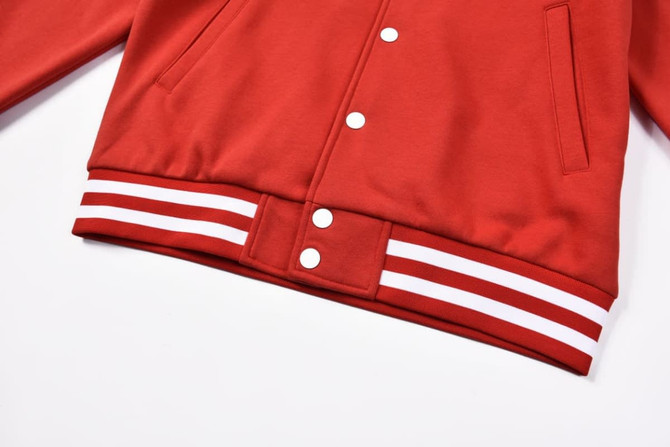 A red varsity jacket featuring a white striped waistband and pockets, designed without any visible branding.