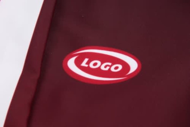 A maroon sports uniform featuring a logo, with white detailing on the side.