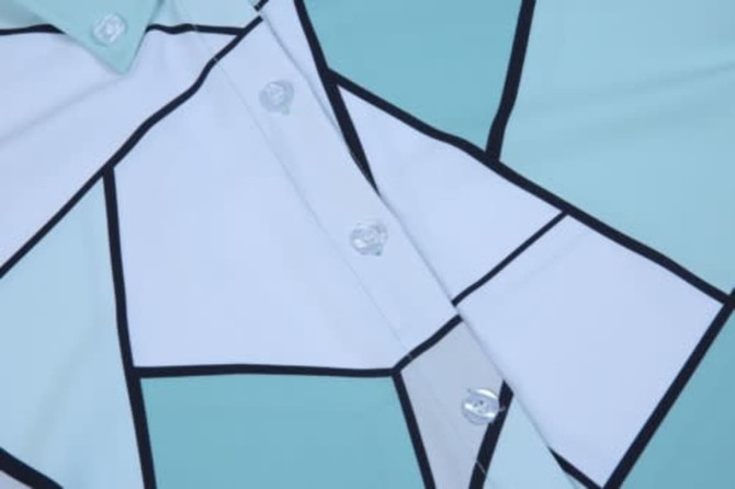 Custom shirt featuring a geometric pattern in shades of teal, white, and black, with buttons in the centre.
