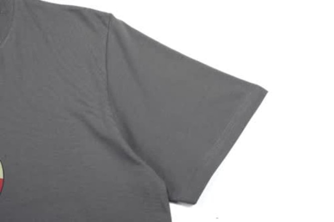 A grey cotton T-shirt with a short sleeve and a logo on the front.