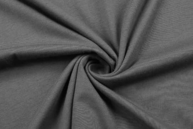 A grey cotton fabric in a spiral pattern, showcasing the texture and softness of the material.