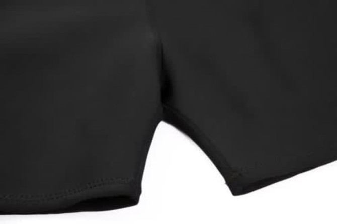 A black swimming coath designed to be anti-chlorine, featuring smooth, stitched edges. It includes a logo.