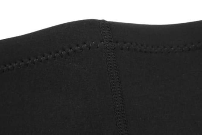 A close-up of black fabric featuring neat stitching, part of an anti-chlorine swimming instructor uniform.