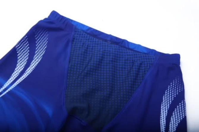 A pair of blue anti-chlorine swimming trunks featuring a design with lighter blue accents and a logo.