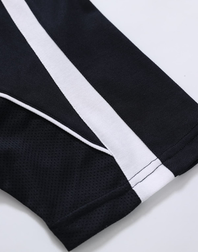 A close-up of a black polo shirt with white stripes, featuring a logo on the fabric.