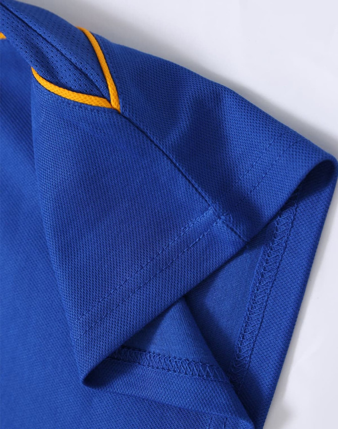 A blue polo shirt with yellow detailing, showcasing the collar and sleeve area. It features a logo.