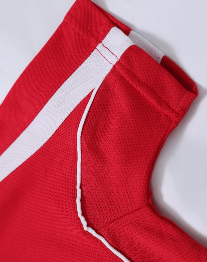A red polo shirt featuring white accent details and a logo on the collar area.