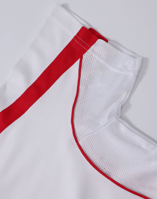 A white polo shirt with red trim, featuring a mesh detail along the collar and shoulder. It has a logo present.