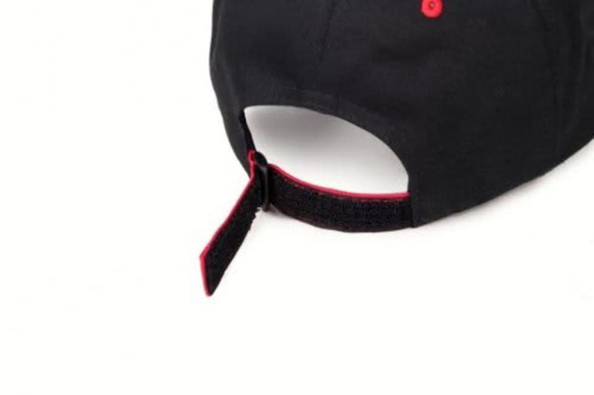 A black cap with red accents and an adjustable strap at the back. It features a logo.
