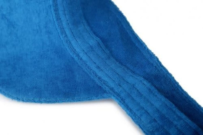 A blue soft peak visor made of fabric, featuring a textured surface and stitched detailing.