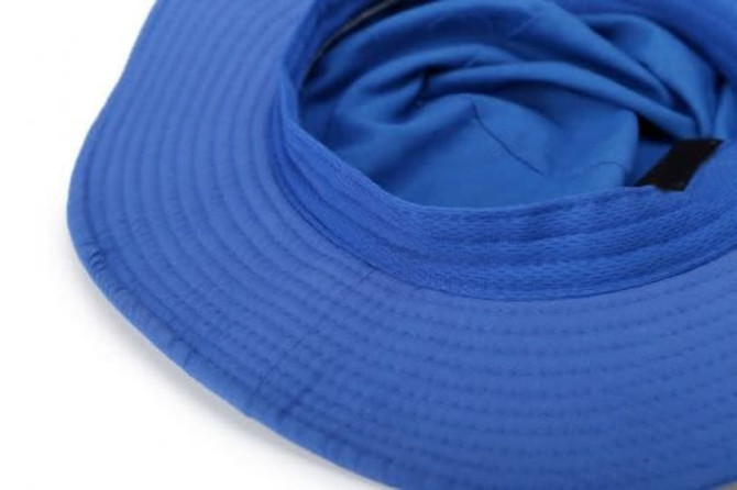 A wide-brim hat in vibrant blue, featuring a textured surface and flexible fabric interior. It has a logo tag included.