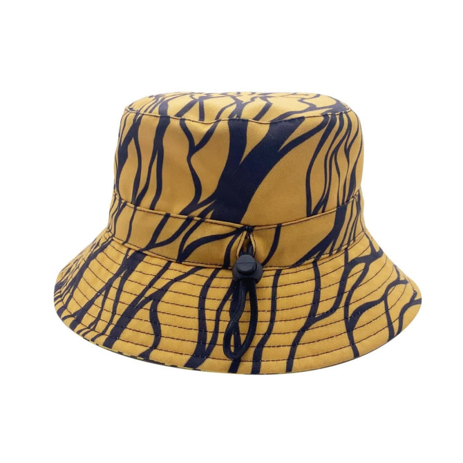 A reversible bucket hat in yellow with a black abstract pattern, featuring a drawstring and a logo.