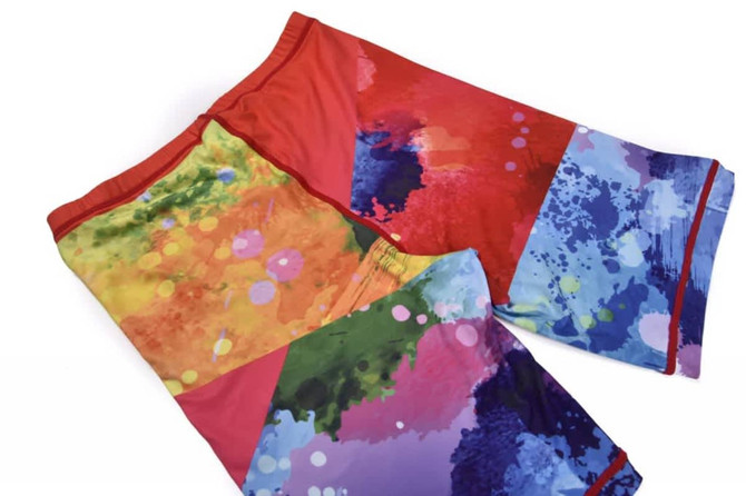 TIGHT JOG LONG SHORTS for ladies in vibrant red, blue, and multicoloured abstract patterns, featuring a logo.
