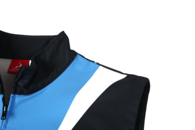 A soft shell waistcoat featuring a blue and black design with a reflective stripe, and a collar. It has a logo.