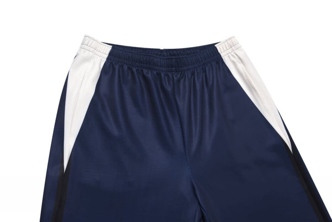 Track pants in navy blue and white, featuring an elastic waistband and side detailing. Includes branding.
