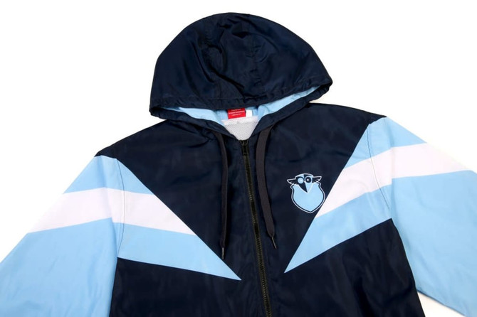 A navy blue and light blue jacket with a hood, featuring white stripes and a logo on the chest.