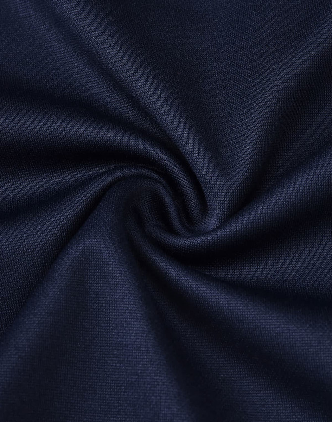 A close-up view of dark navy fabric with a smooth texture, showcasing its soft and sustainable qualities.