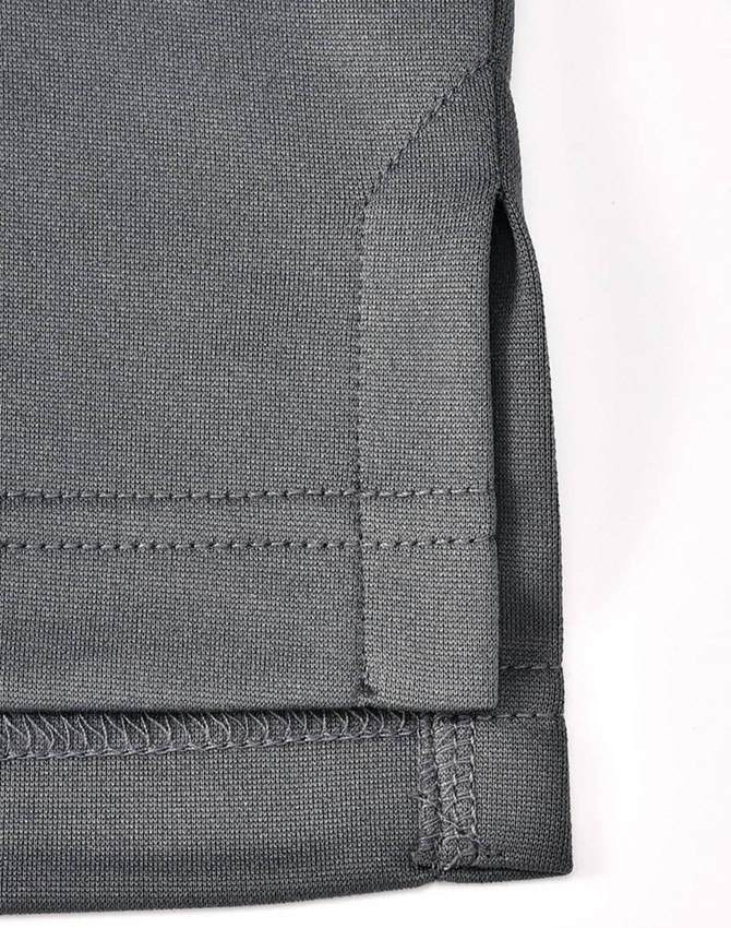 A grey sustainable poly/cotton polo shirt featuring detailed stitching and a side vent design.