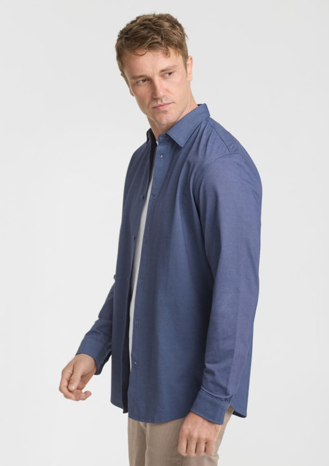 A long sleeve shirt in navy blue, featuring a relaxed fit and a subtle texture. It includes a logo on the label.