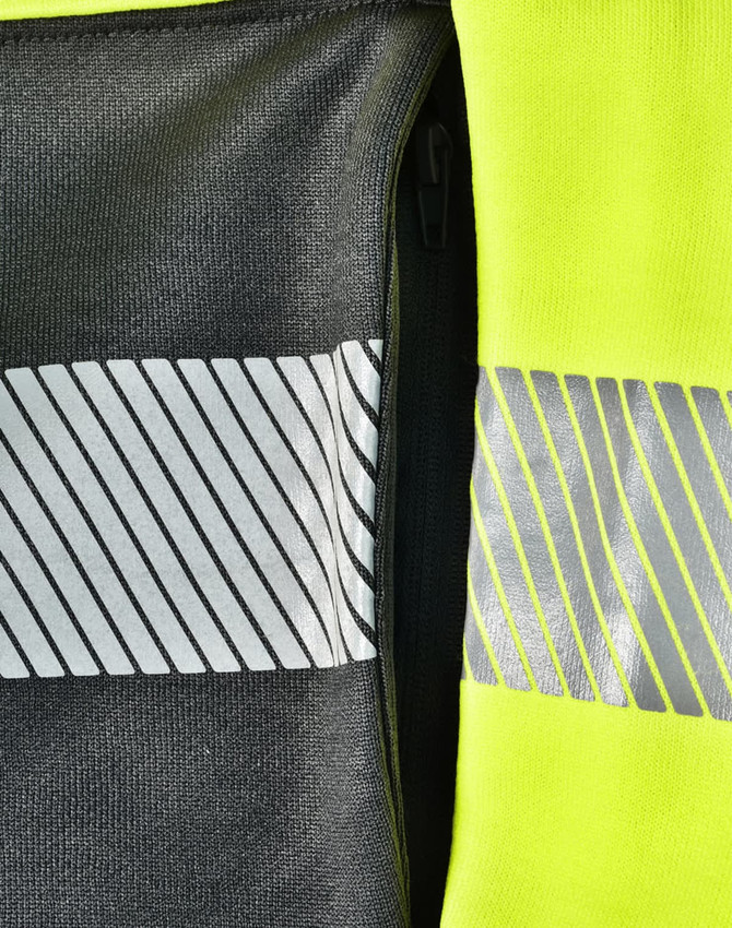 A bright yellow work jumper featuring reflective stripes and a zipper pocket in a contrasting dark grey fabric.