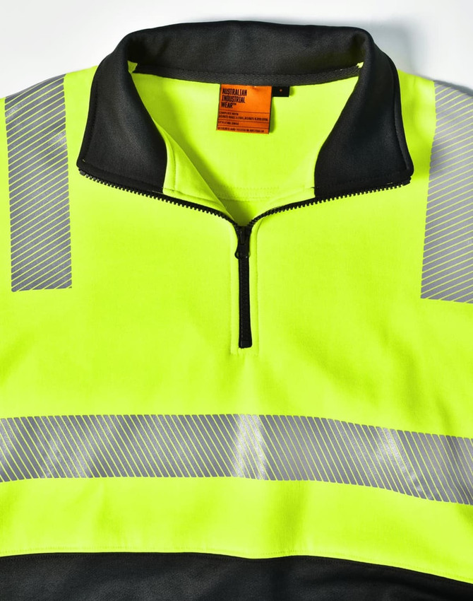 A high-visibility jumper in fluorescent yellow and black, featuring reflective stripes and a zippered collar.