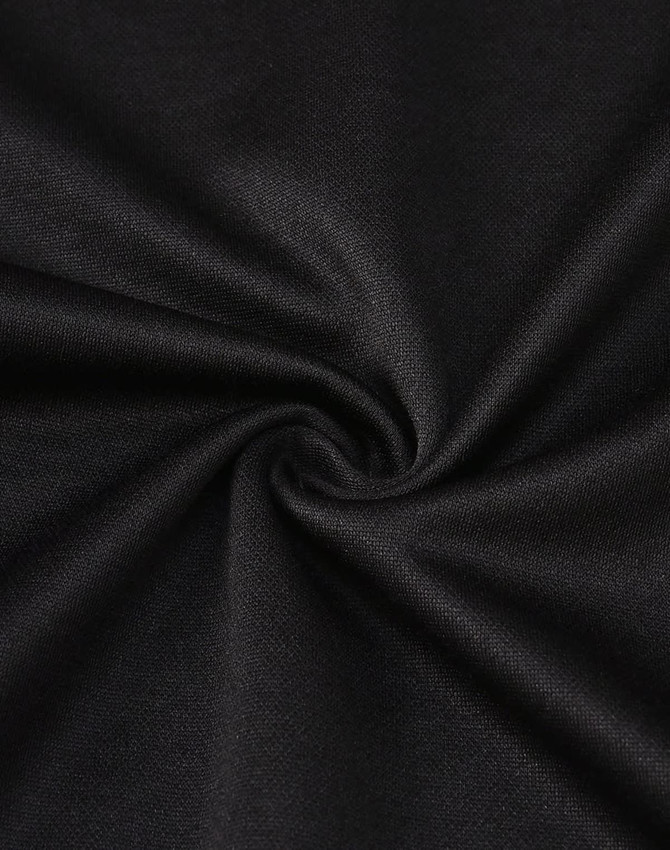A close-up of black fabric showcasing a smooth, sustainable poly/cotton blend with a subtle texture.