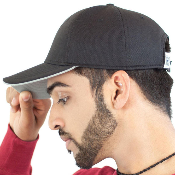 A black cap with a contrasting under-peak, featuring a logo and worn by a model.