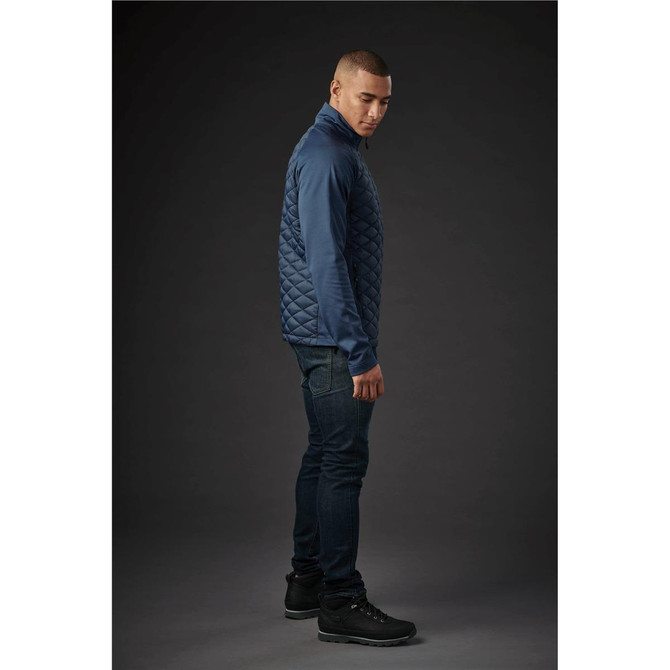 A men's quilted thermal shell jacket in navy blue, featuring a high collar and a fitted design. It has a logo present.