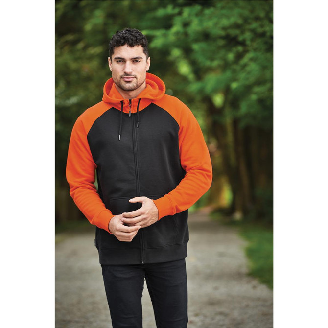 A men's zip hoodie in black and orange, featuring a hood and contrasting sleeves, set in a natural outdoor environment.