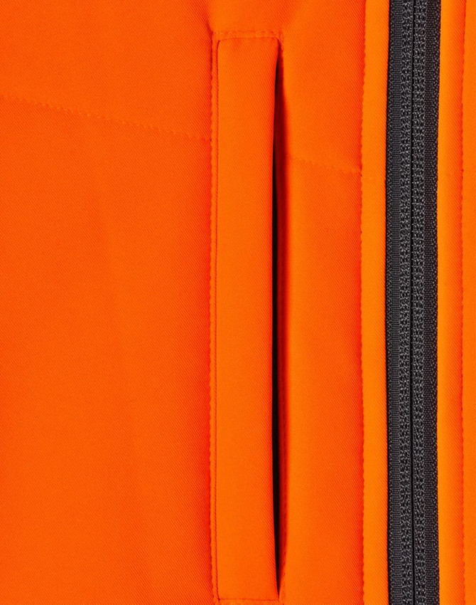 A close-up of an orange fabric featuring a zippered pocket, part of a safety jacket design.