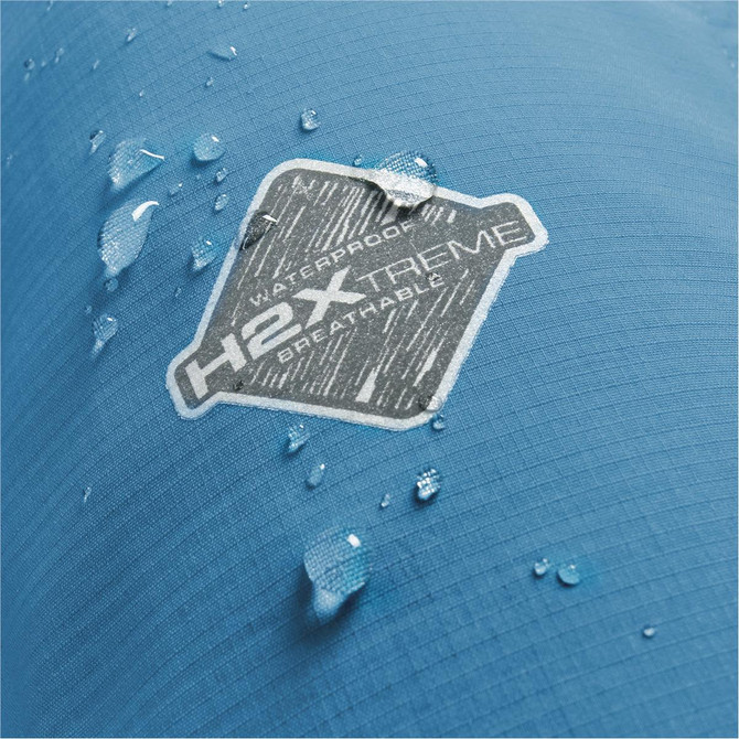A close-up of the blue fabric of the Men's Epsilon H2Xtreme Shell jacket, featuring water droplets and a logo.