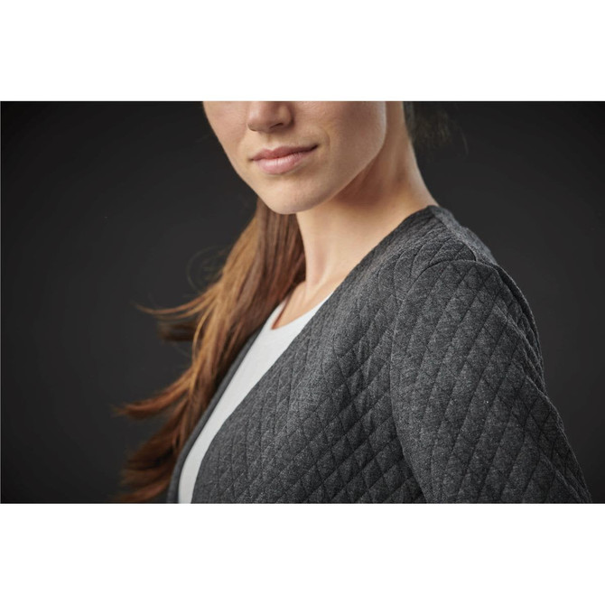 A close-up of a woman wearing a dark grey, quilted women's Chelsea open cardigan, featuring a casual style.
